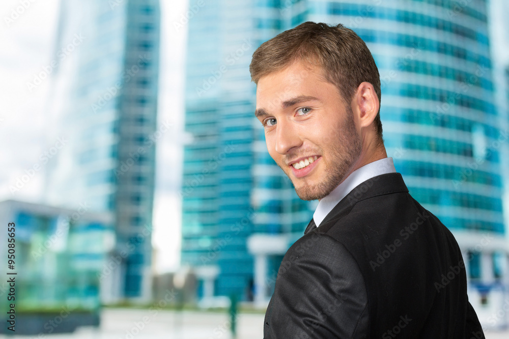 Young Businessman looking over his shoulder Young Businessman looking over his shoulder