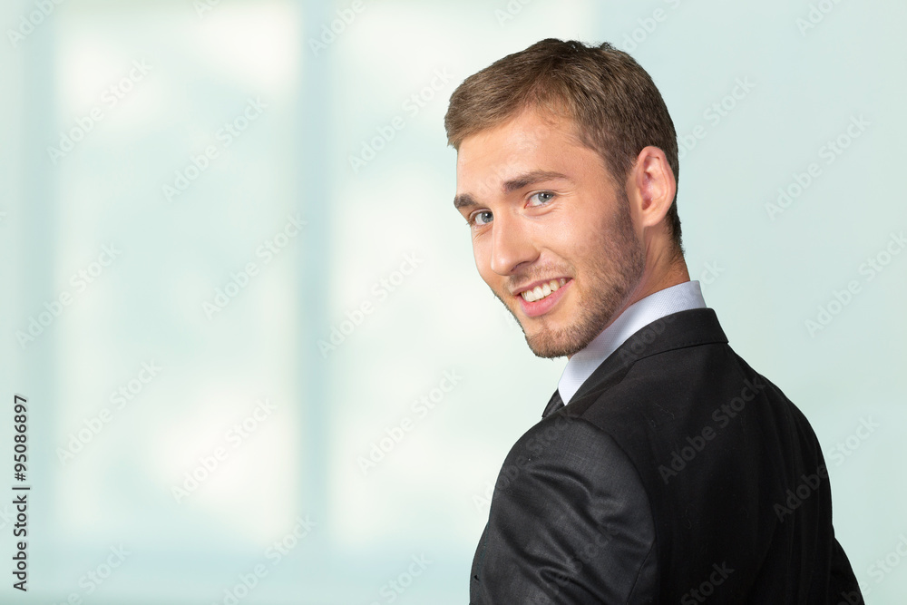 Young Businessman looking over his shoulder Young Businessman looking over his shoulder
