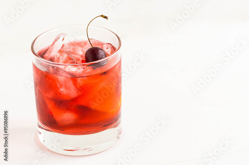 Old fashioned cocktail on white wooden background