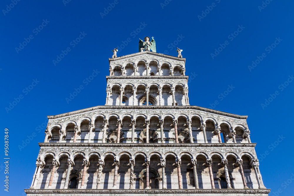 Upper front facade of San Michele in Foro church in Lucca, Tuscany, Italy