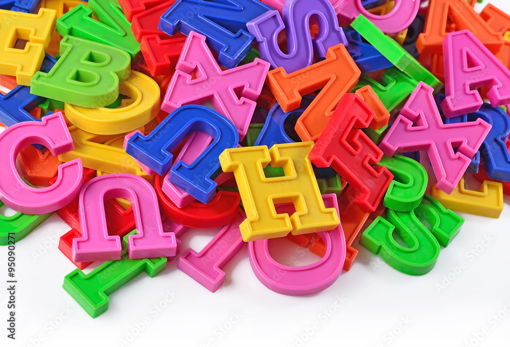 Colorful plastic alphabet letters on a white Colorful plastic alphabet letters on a white