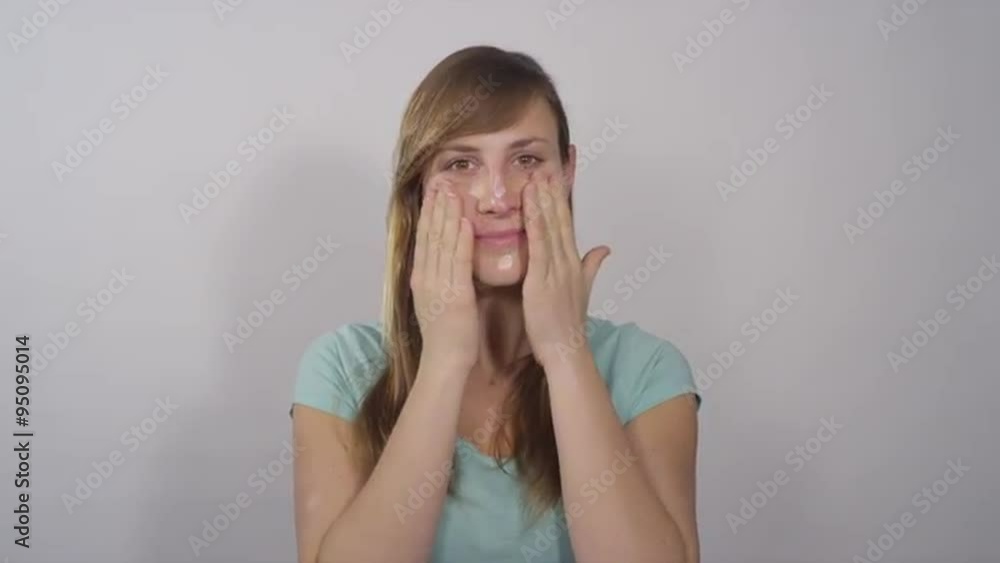 Female applying face cream Female applying face cream