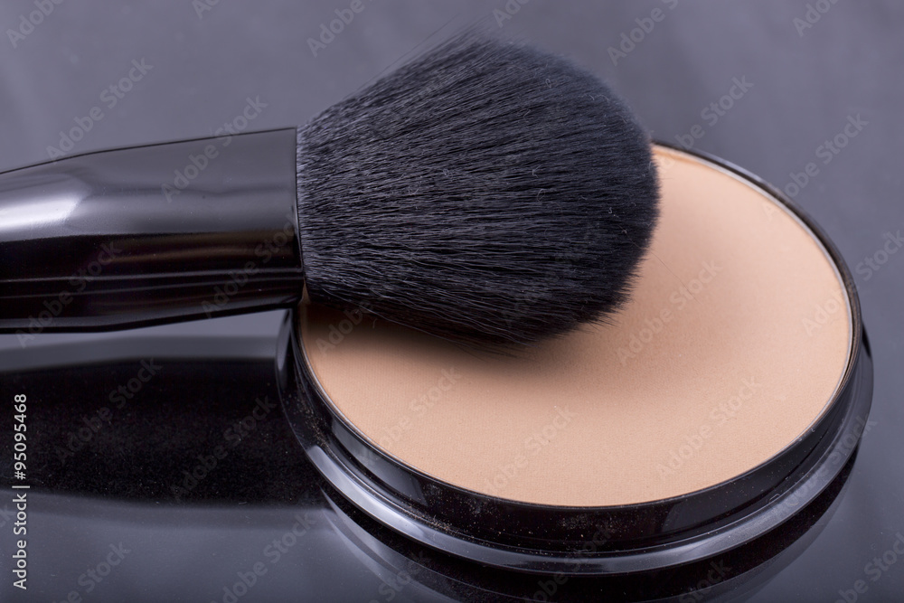face powder with a brush close up on a white background face powder with a brush close up on a white background