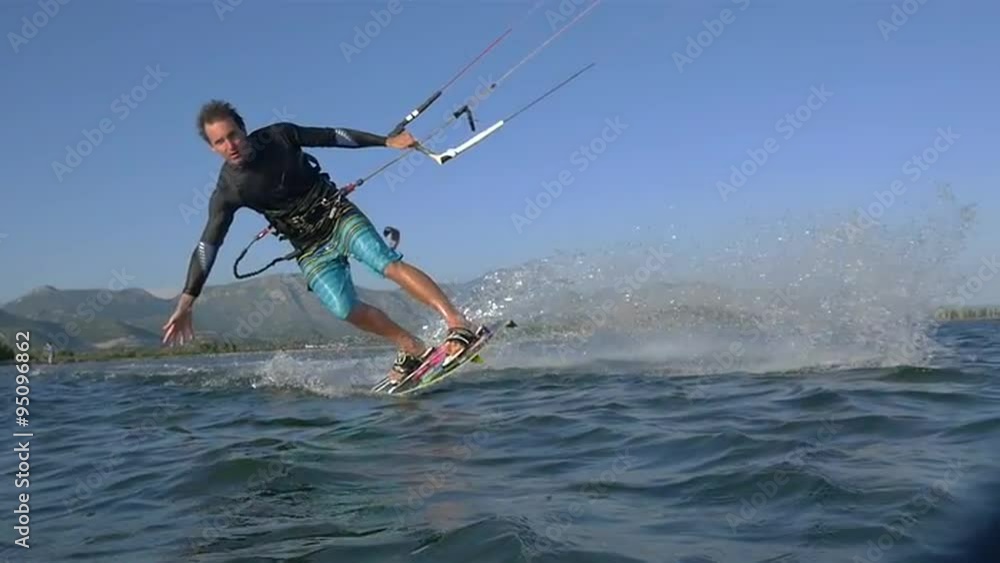 SLOW MOTION: Young kiteboarder riding toeside SLOW MOTION: Young kiteboarder riding toeside