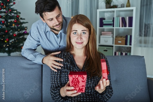 girlfriend looks sceptical to her christmas gift