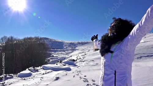 Hands raised on the snow mountain top.  photo