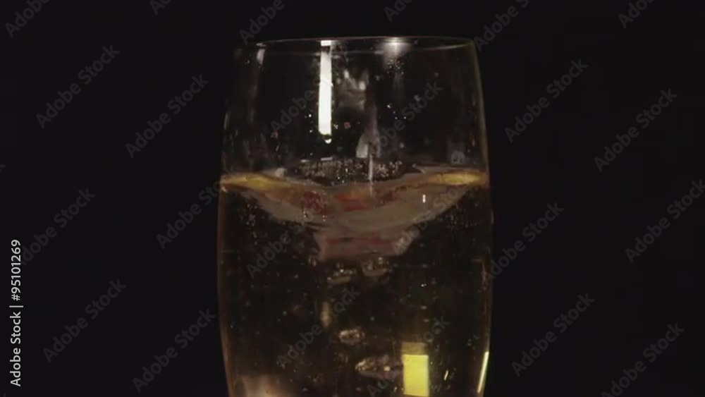 SLOW MOTION CLOSE UP: Strawberries falling into the champagne SLOW MOTION CLOSE UP: Strawberries falling into the champagne