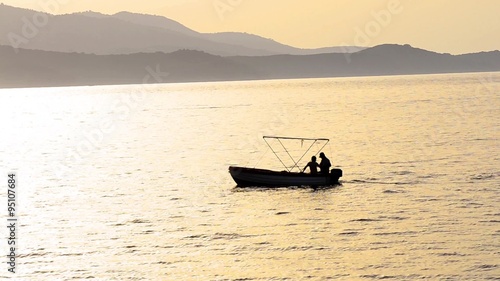 Canoe with fishing man on a lake  photo