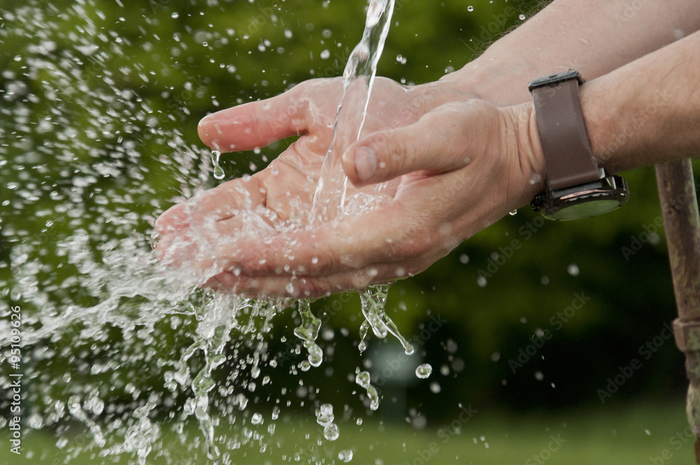 Fototapeta premium men's hands under running cold water