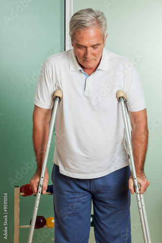 elder man using a crutches