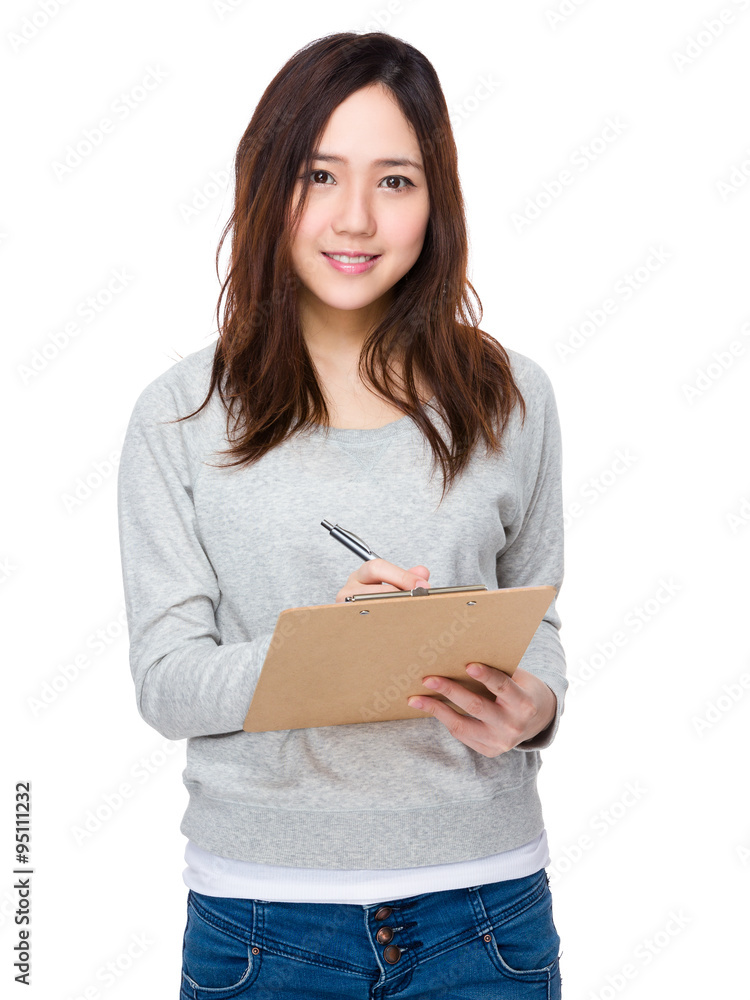 Asian Young Woman write on the clipboard Asian Young Woman write on the clipboard