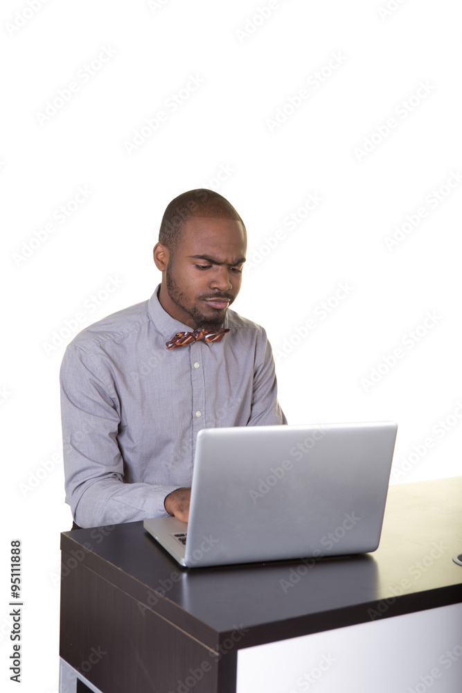 A young man or teenager working at a computer A young man or teenager working at a computer
