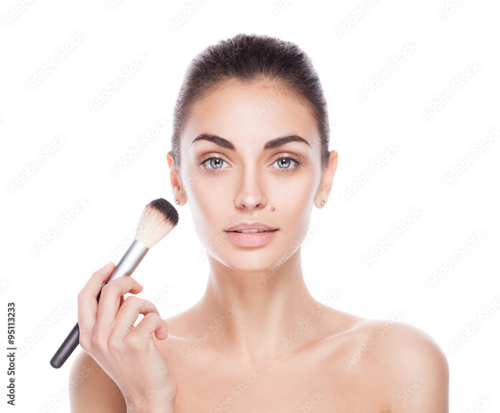 Portrait of woman with makeup brush near her face Portrait of woman with makeup brush near her face