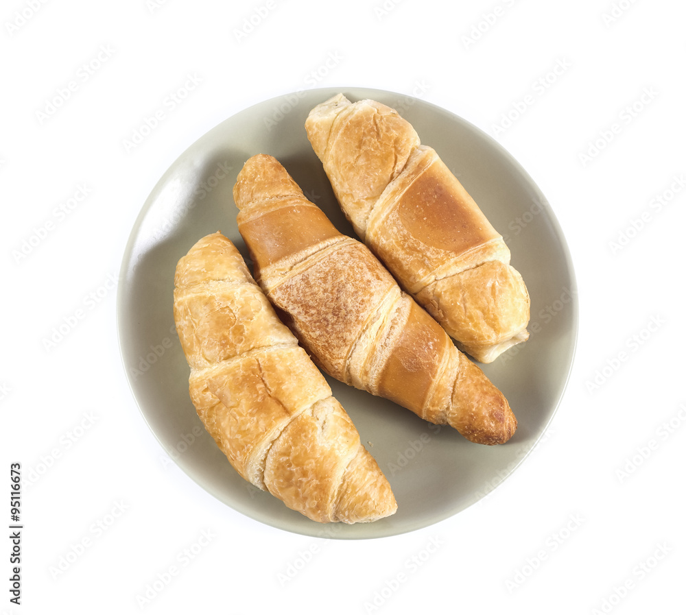 Fresh croissants on green plate isolated on white Fresh croissants on green plate isolated on white
