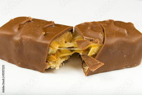 two slices of Snickers bars on a white background macro photo