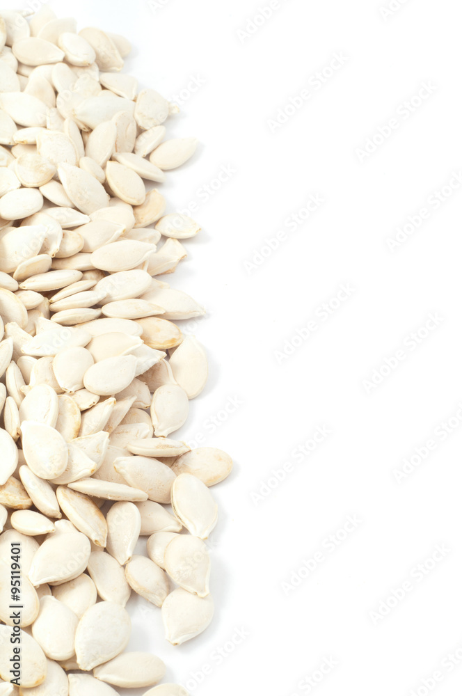 Texture of Shelled pumpkin seeds separately on a white backgroun Texture of Shelled pumpkin seeds separately on a white backgroun