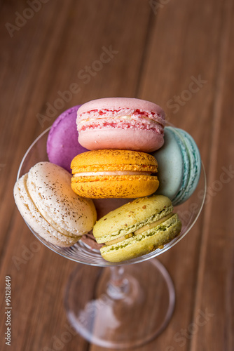 mix macaron in the martini glass on the wooden table