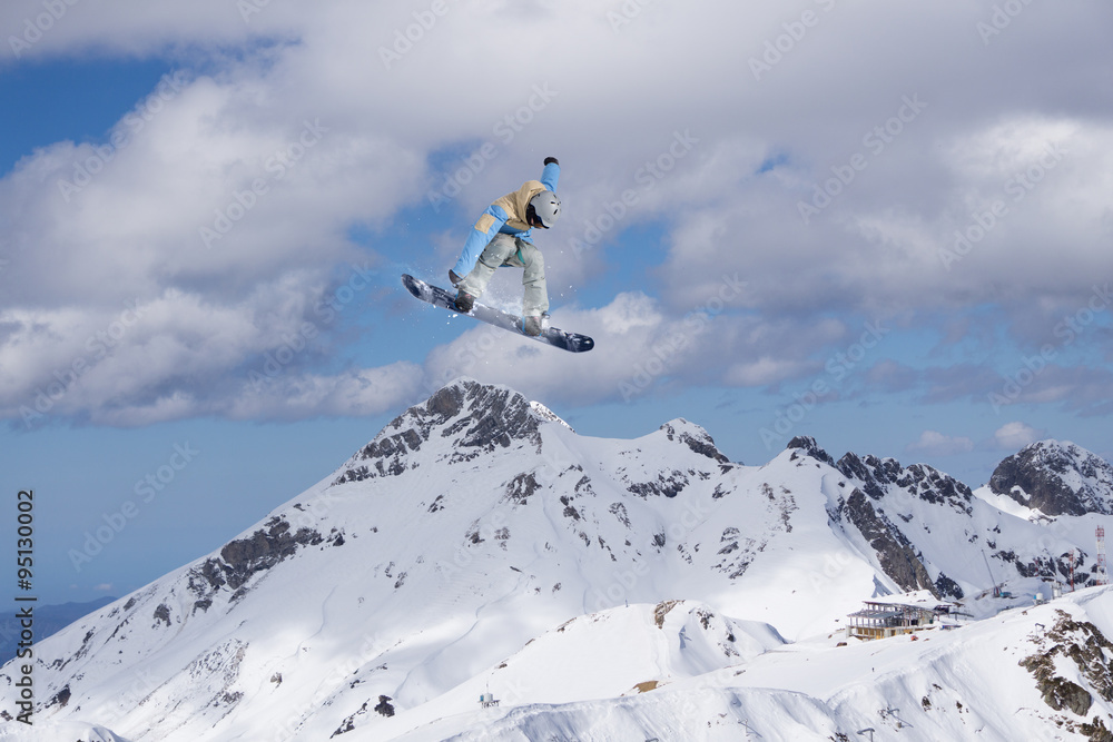 Flying snowboarder on mountains, extreme sport Flying snowboarder on mountains, extreme sport