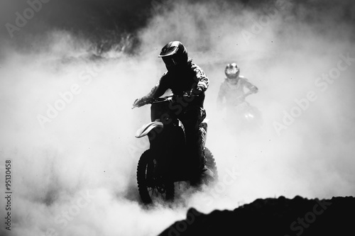 Fototapeta Naklejka Na Ścianę i Meble -  Motocross racer accelerating in dust track, Black and white, hig