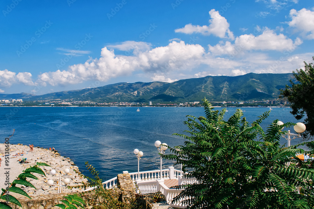 Fototapeta premium Sea under the blue sky on background of mountains