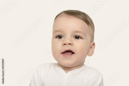 Cute baby boy smiling. Adorable happy laughing baby portrait isolated on white.
