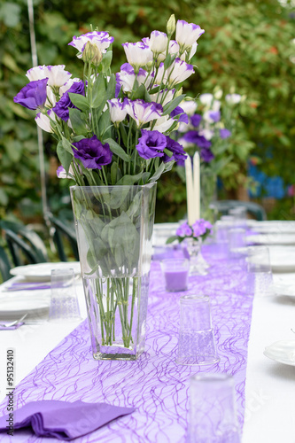 Outdoors table set up for a party in purple and white