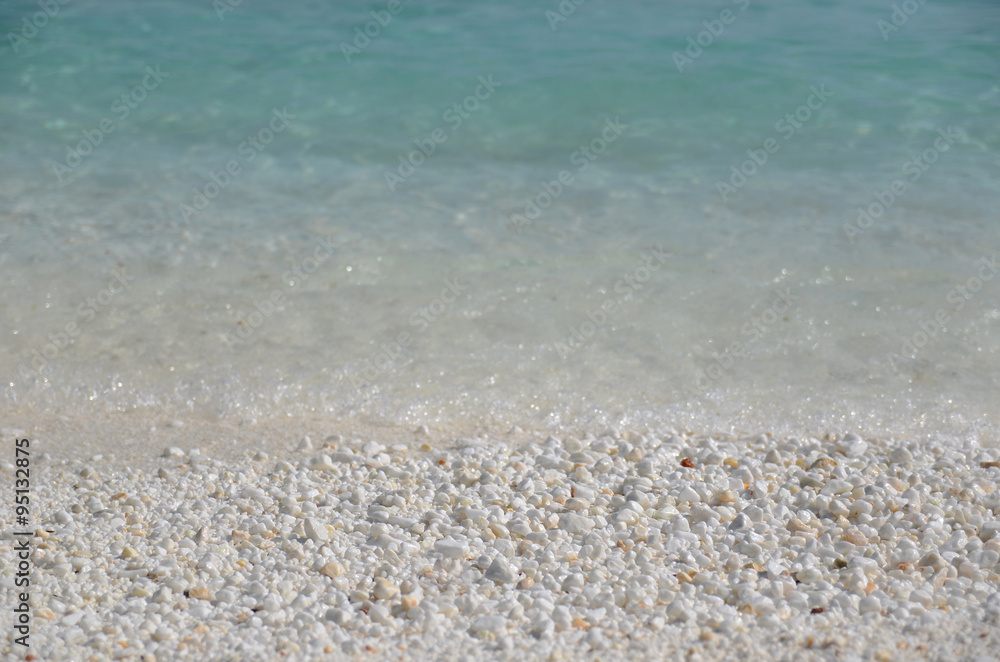 Marble sand and small stones on the sea shore