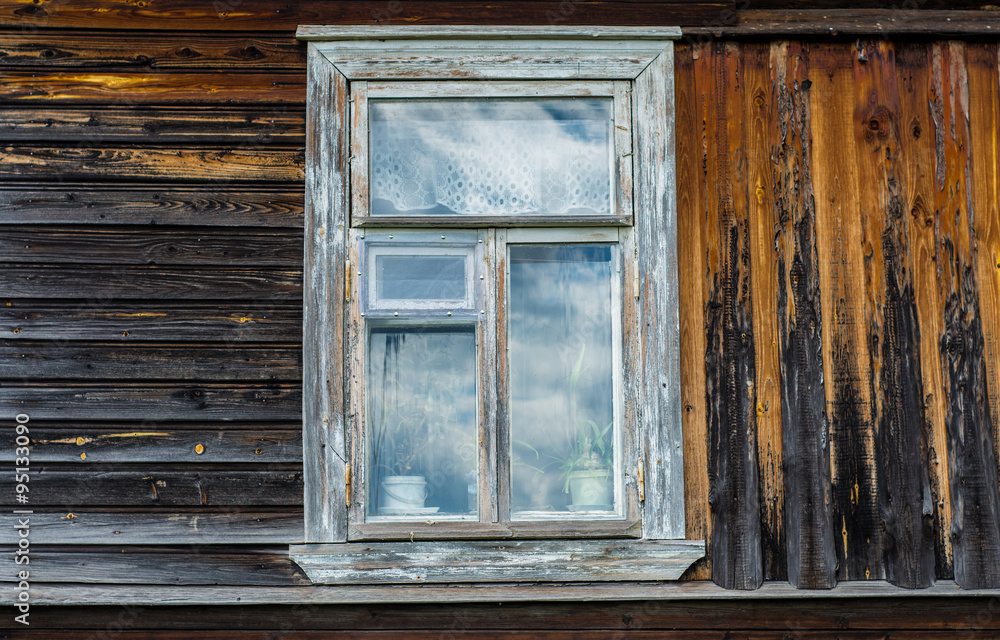 Wooden box with a white frame is located in an old wooden house. Wooden box with a white frame is located in an old wooden house.