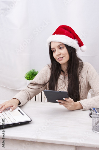 girl with christmas hat and computer