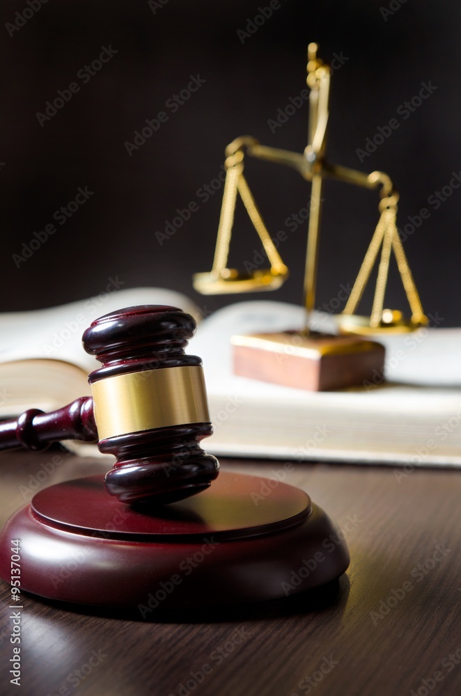 Wooden gavel and books on wooden table Wooden gavel and books on wooden table