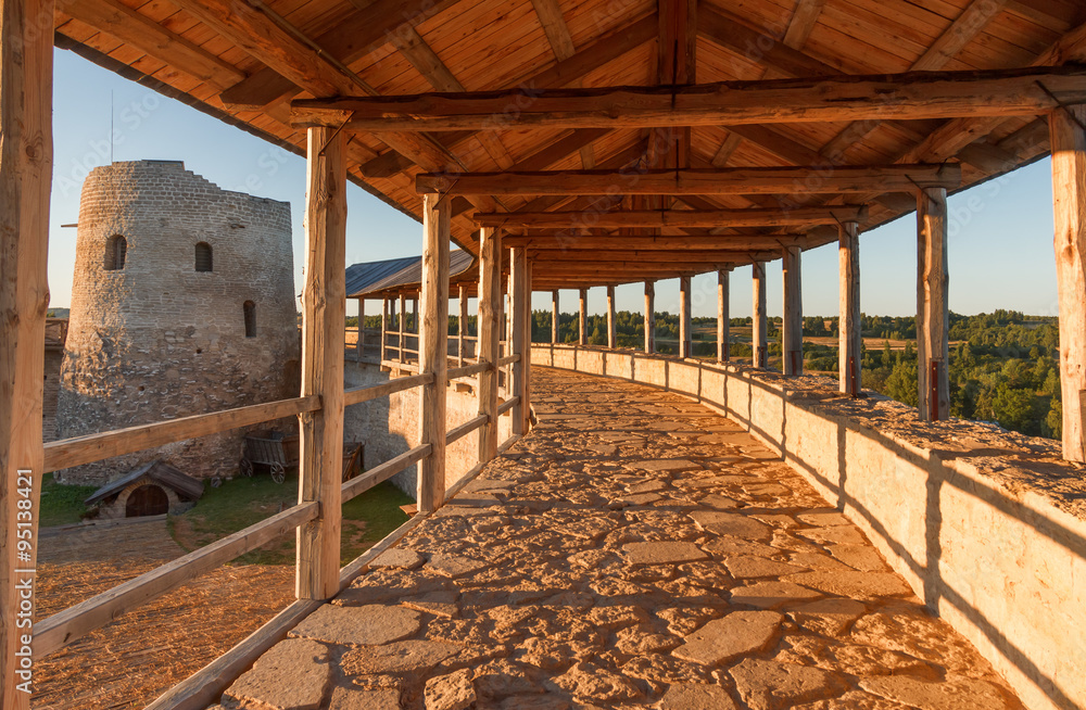 On the wall of an ancient fortress in Izborsk summer sunny evening
