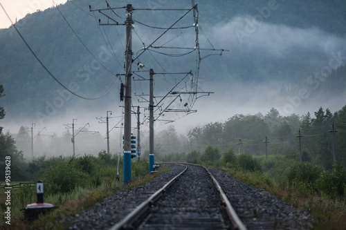 Russian railway among hills in the fog