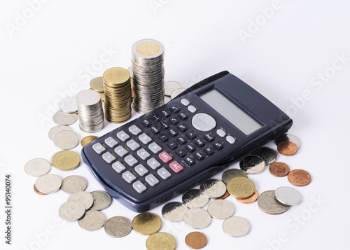 Calcuator and coins stack for business finance concept background