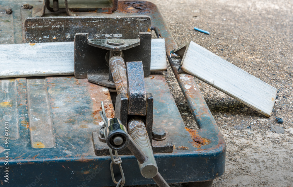 A triangle metal and steel with compound mitre saw with circular blade A triangle metal and steel with compound mitre saw with circular blade