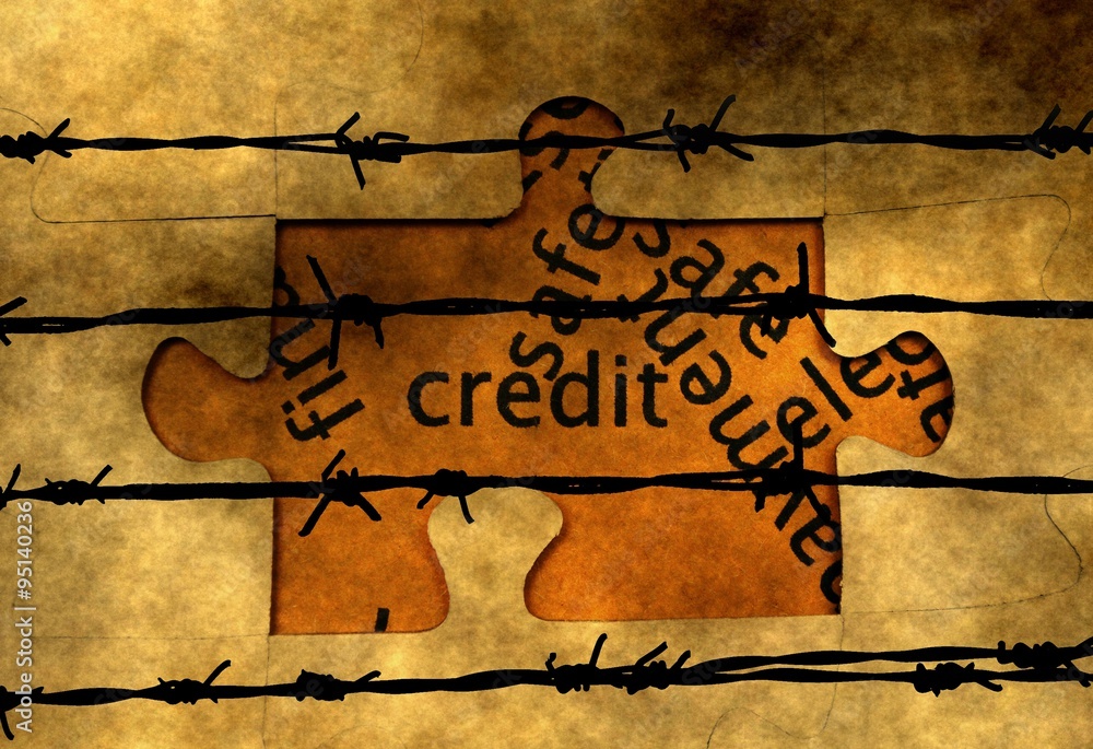 Credit puzzle concept against barbwire