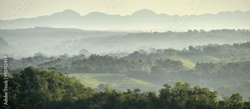 Photography View across the Vinales Valley in Cuba. Morning twilight and fog.