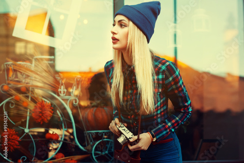 Photography Portrait of beautiful young playful hipster woman with old retro camera