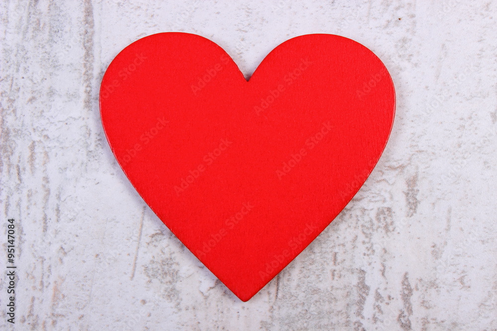 Valentine red heart on old wooden white table, symbol of love Valentine red heart on old wooden white table, symbol of love