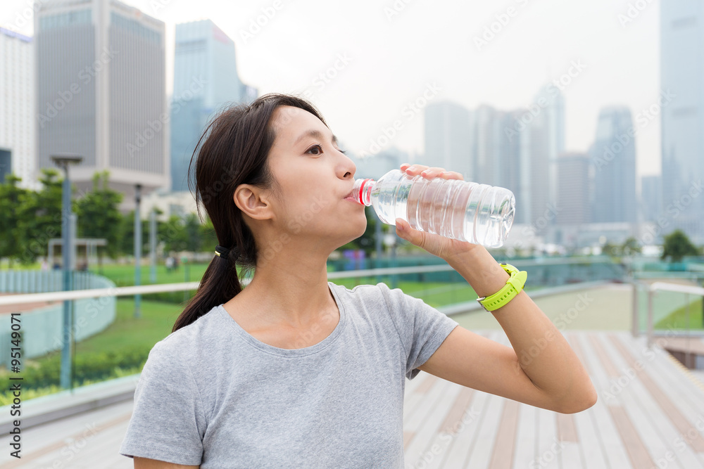 Sport woman drink water after running Sport woman drink water after running