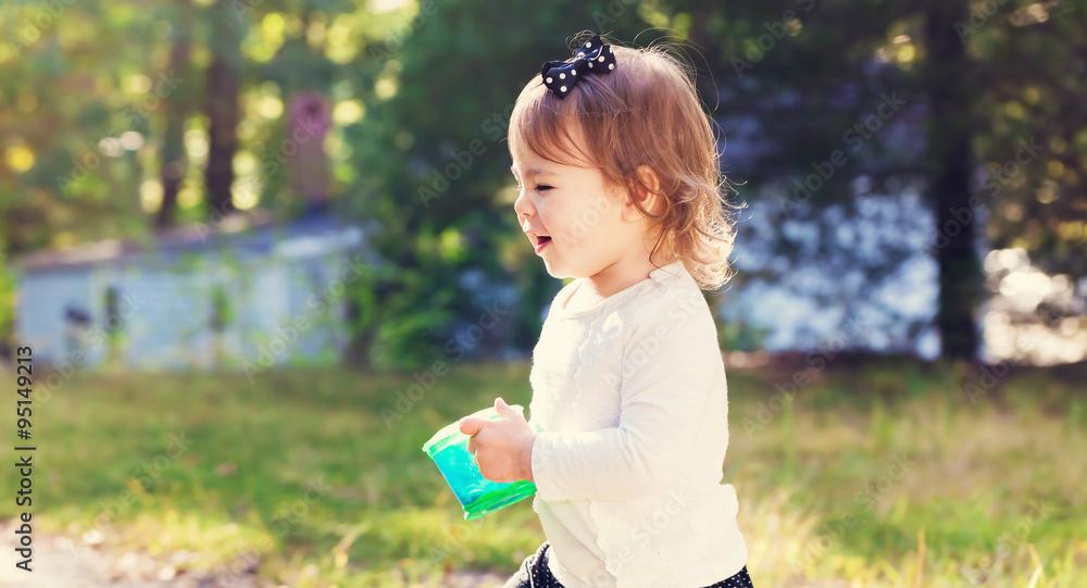 Happy toddler girl playing outside Happy toddler girl playing outside