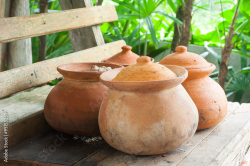 Clay pots or porttery on a shelf  outside kitchen room © tumsubin