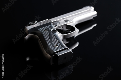 handgun on black background
