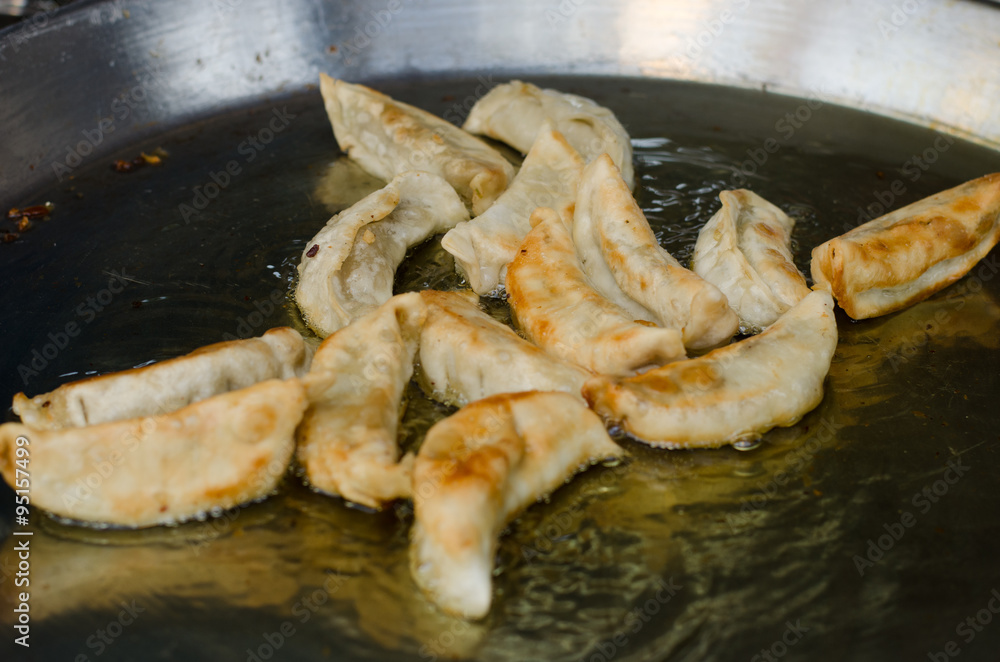 making Gyoza (Japanese Dumplings) in frying pan making Gyoza (Japanese Dumplings) in frying pan