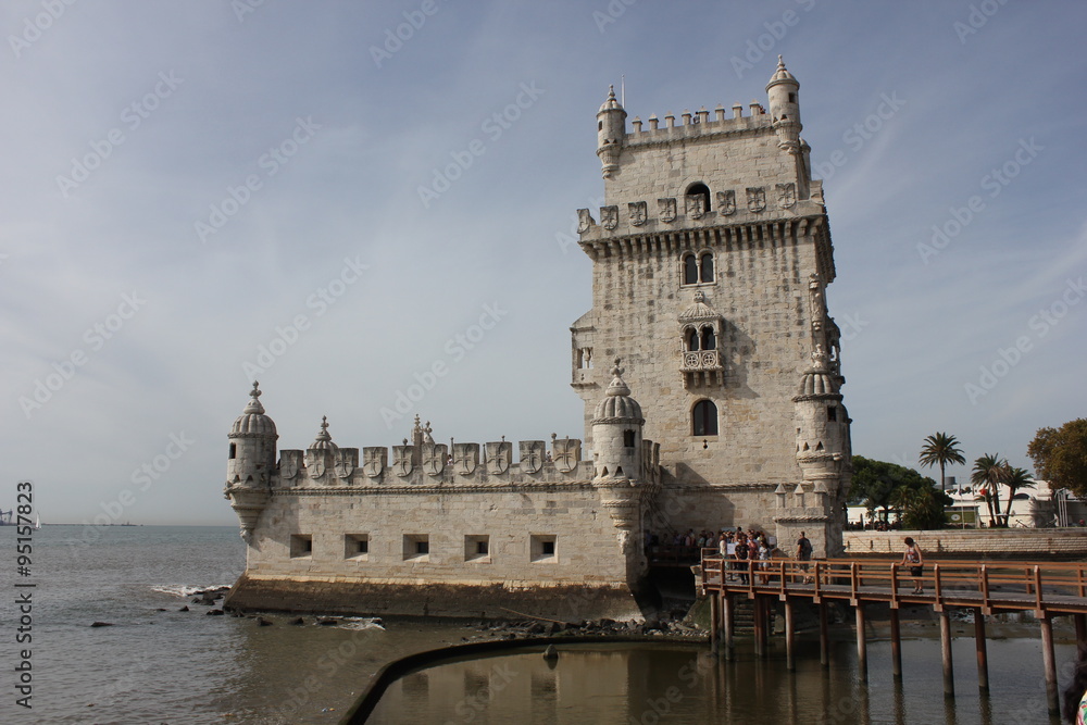 Belem Tower of Lisbon, Unesco world heritage, with people on the bridge