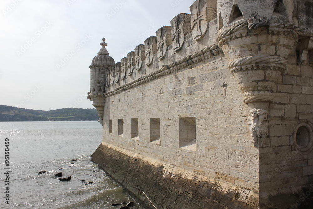 Close up detail of the Bastion terrace of Belem Tower, with its Moorish bartizan turrets during the ebb tide