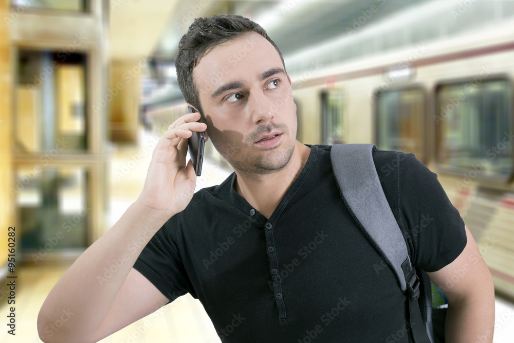 Man lost in subway speaking on a cell phone Man lost in subway speaking on a cell phone