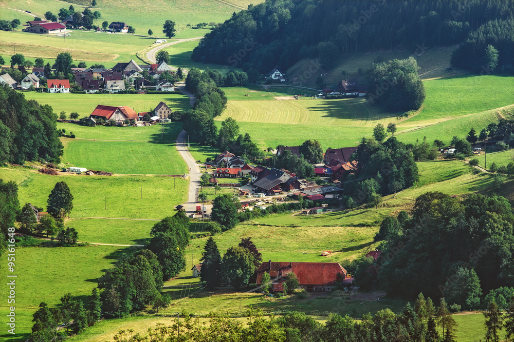 Scenic aerial landscape: summer mountain valley with forests, fields and village in Germany, Black Forest