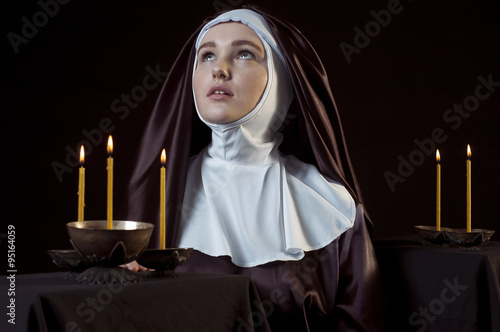 Nun with candles.
