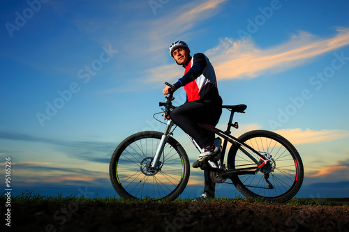 young adult cyclist riding mountain bike in the countryside