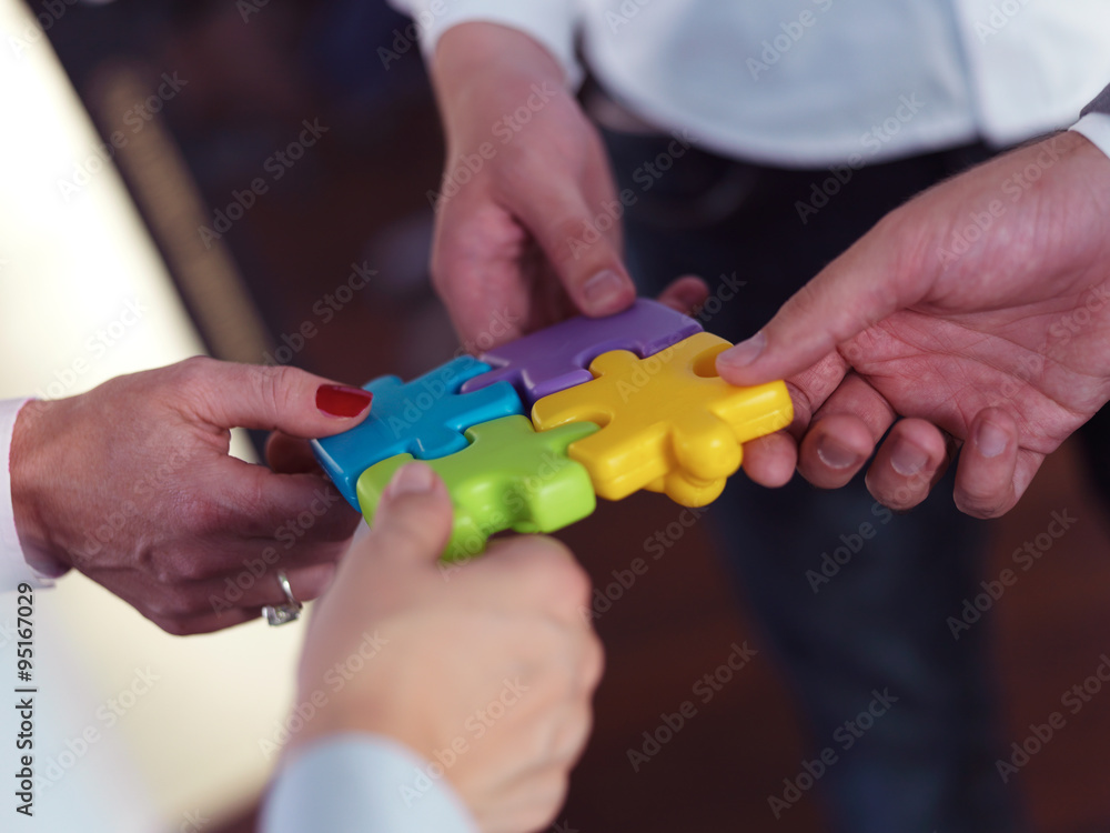 business people group assembling jigsaw puzzle